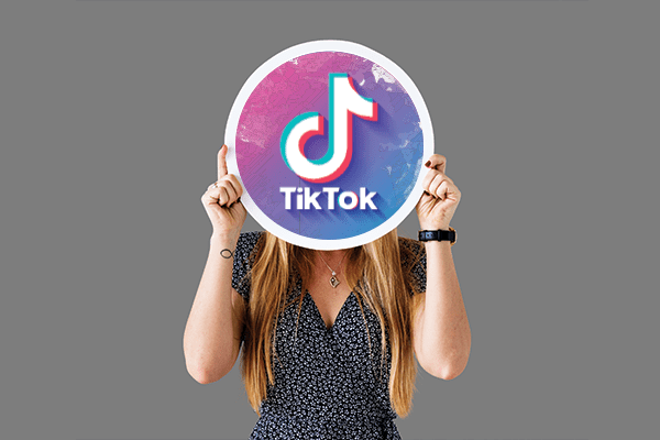 Woman holding the TikTok logo.