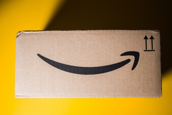 Amazon delivery box on a yellow background.